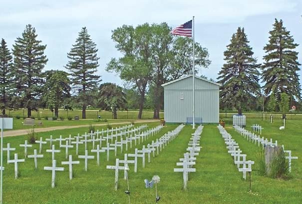 Flag flies with honor over veterans’ white crosses